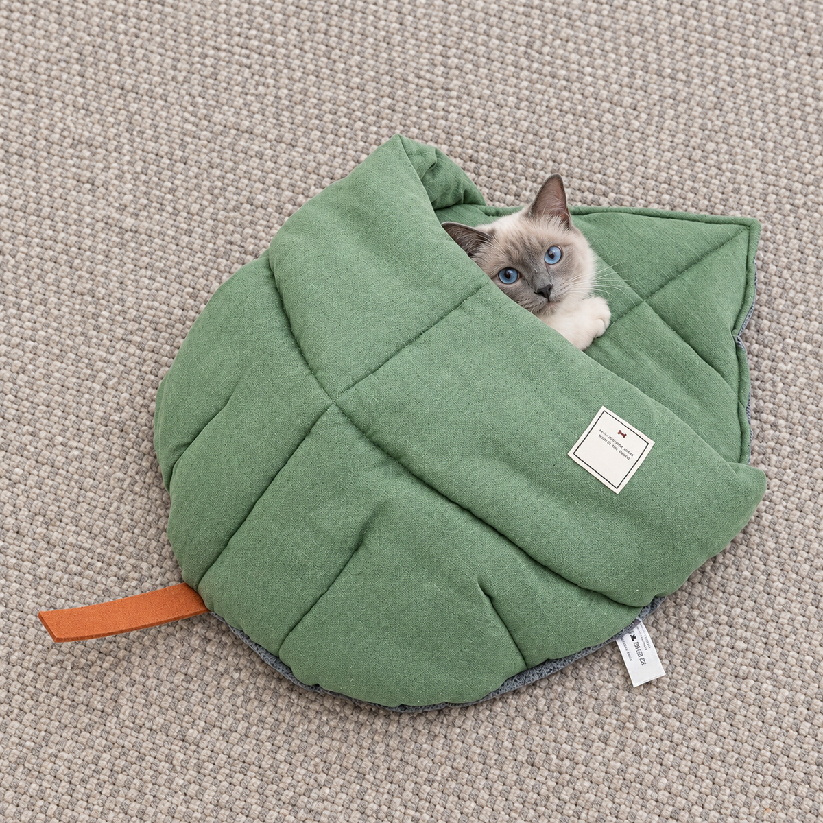 Pet peeking from the quilted leaf sleeping bag