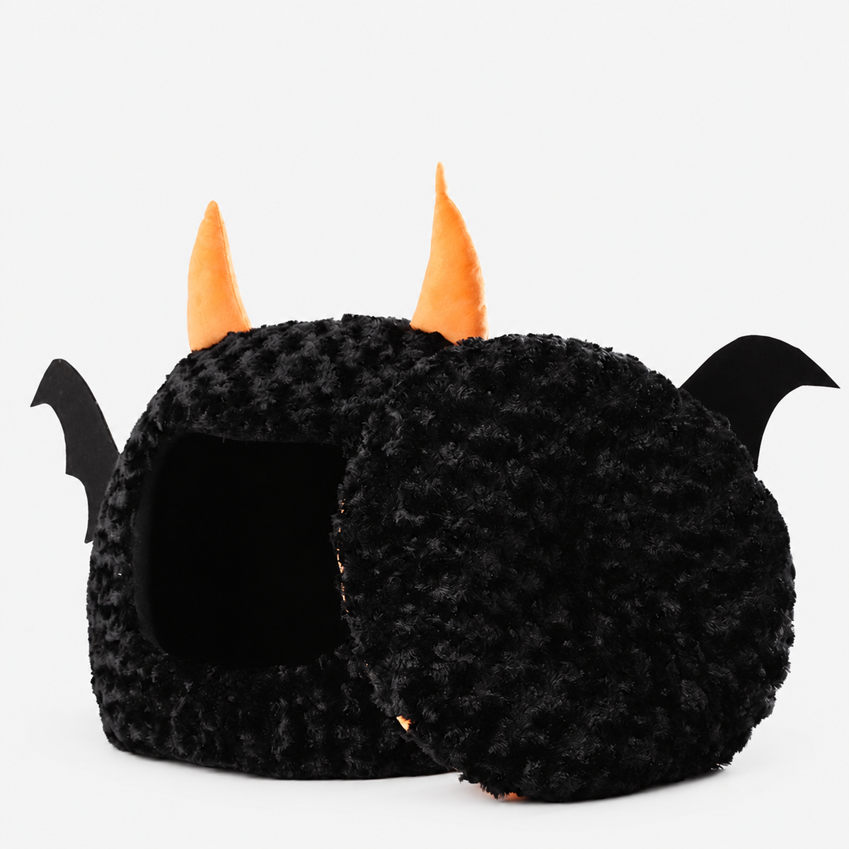 Black bat pet cave with its cushion propped beside the entrance