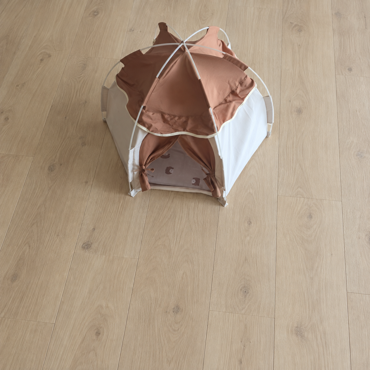 Overhead view of a pet tent on a wooden floor