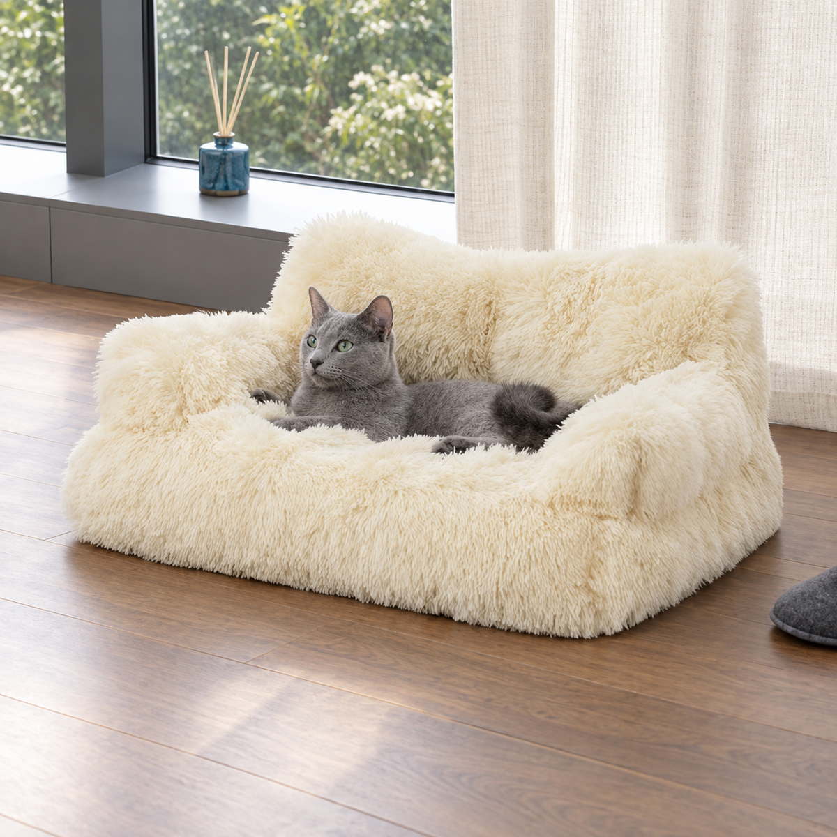 Beige fluffy pet sofa with a cat by a window