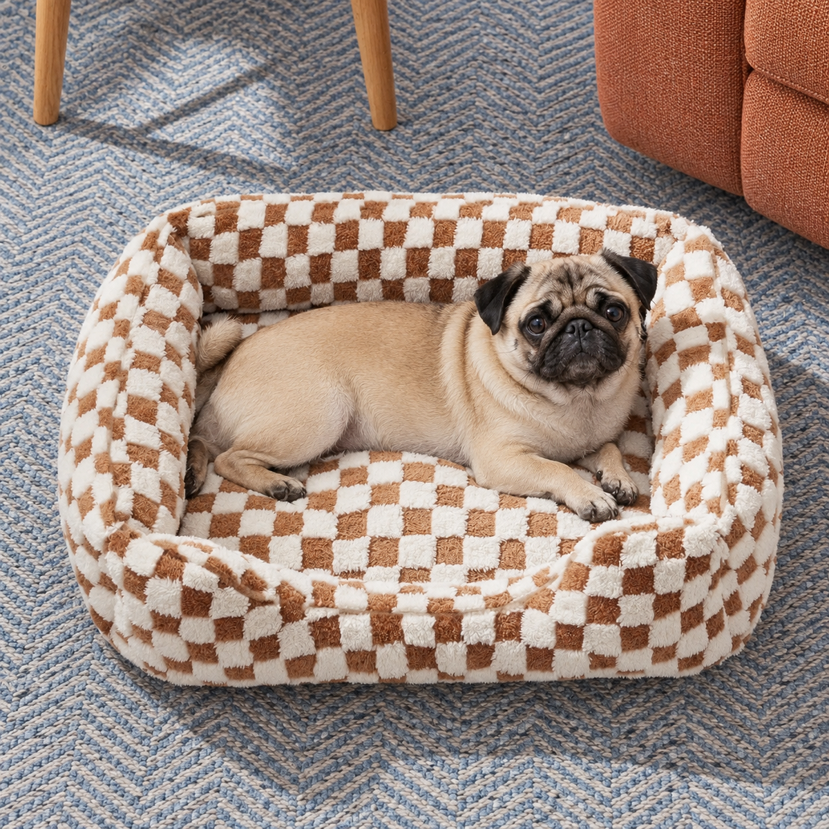 Brown checked bolster bed viewed from above with a pug