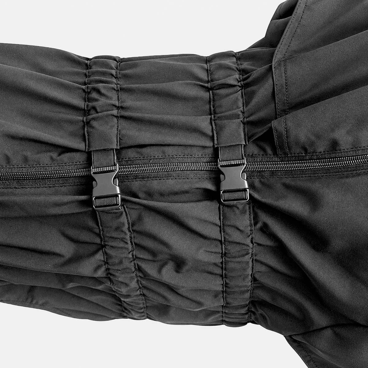 Close view of adjustable dog raincoat buckles